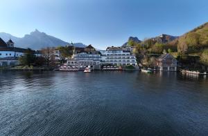 a view of a river with houses and buildings at Das Traunsee - Das Hotel zum See 4 Stern Superior in Traunkirchen