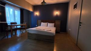 a small bedroom with a bed and a table at Elizim Otel in İzmir