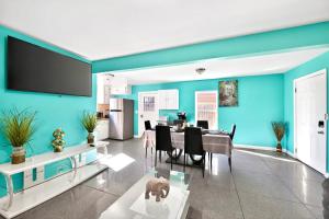 a living room with blue walls and a dining room at San Diego 3BR & 3BA Comfortable Home, Outdoor Kitchen, Firepit & BBQ, 10 to 15min from SeaWorld & Zoo in San Diego