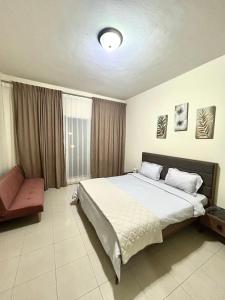 a bedroom with a large bed and a chair at Beachfront Luxury Stay with private beach 2 bedroom in Ras al Khaimah +16 photos