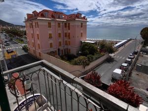a large pink building on the side of a street at Hotel Aurora in Varazze