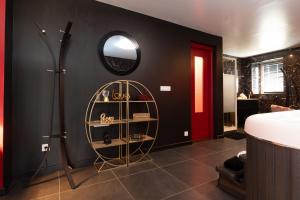 a bathroom with a shower and a mirror on the wall at Le Cocon secret - Sauna - Jacuzzi in Quimperlé
