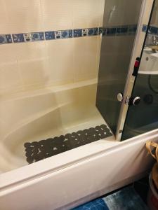 a shower with a glass door in a bath tub at Experience at Malinova dolina in Sofia +72 photos
