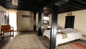 a bedroom with a bed and a desk and a chair at Traditional Homes - Swotha in Pātan