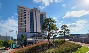 a tall building with a sign on top of it at Ulsan Tanibay Hotel & Wedding in Ulsan