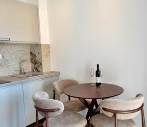 a kitchen with a table and chairs and a counter at Maresa 8 in Čanj +7 photos