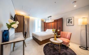 a hotel room with a bed and a desk and a table at Hotel the Castle Jamsil Sports Complex in Seoul