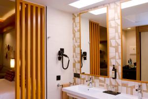 a bathroom with a sink and a mirror at Hotel Riu Touareg - All Inclusive in Curral Velho