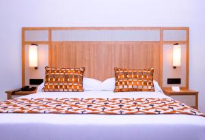 a bedroom with a large bed with two pillows at Hotel Riu Touareg - All Inclusive in Curral Velho +13 photos