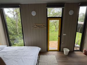 a bedroom with a bed and a door to a yard at Mountain Calm Inns in Xiayun