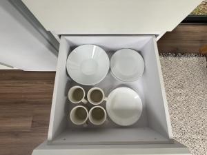 a drawer with four white plates in it at Mountain Calm Inns in Xiayun