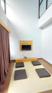 a yoga room with a row of mats on the floor at Villa Takasima Berastagi in Berastagi