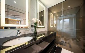 a bathroom with a sink and a glass shower at Hotel the Castle Jamsil Sports Complex in Seoul +120 photos