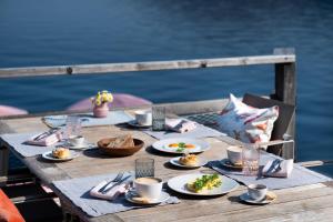 a wooden table with plates of food on it at Das Traunsee - Das Hotel zum See 4 Stern Superior in Traunkirchen +38 photos