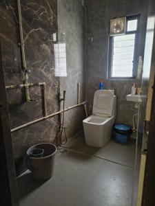a bathroom with a toilet and a sink at PnH Stays in Siliguri
