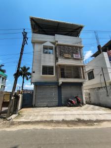 a house with a scooter parked in front of it at PnH Stays in Siliguri