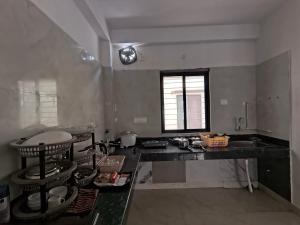 a kitchen with a sink and a counter top at PnH Stays in Siliguri