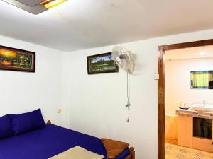 a bedroom with a blue bed and a fan at Sunny Bungalow in Koh Rong Sanloem +53 photos