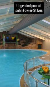 a swimming pool in a hotel room with a swimming pool at Blue Skies in St Ives