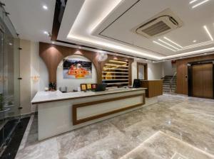 a lobby with a reception desk in a building at Maa Trinayani Palace in Katra