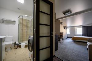a bathroom with a door open to a room at Grecheskaya Central Suites in Odesa