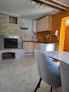 a kitchen with a table and chairs in it at Котедж На Лузі in Verkhne-Studënyy