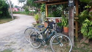 two bikes are parked next to a house at Wattana Bungalow in Nai Yang Beach