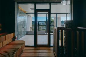an open glass door with a view of a balcony at FAV LUX Miyazaki in Miyazaki