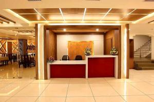 a lobby with a reception desk in a building at Heyday INN in Pathanāmthitta