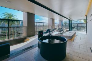 a large living room with a tub and a large window at FAV LUX Miyazaki in Miyazaki +57 photos