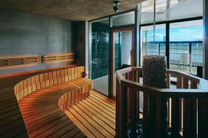 a balcony with benches and a view of a building at FAV LUX Miyazaki in Miyazaki