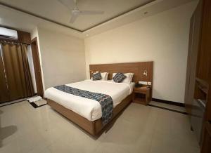 a bedroom with a large bed and a window at Heyday INN in Pathanāmthitta