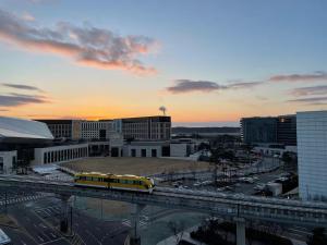a yellow train on a bridge in a city at Self Check-in Only Residence near Incheon Airport T1 & Paradise City in Incheon +6 photos