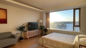 a bedroom with a bed and a large window at Self Check-in Only Residence near Incheon Airport T1 & Paradise City in Incheon