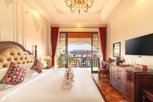 a large bedroom with a bed and a television at The Jam Central in Luang Prabang