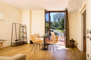 a dining room with a table and chairs and a balcony at Santoro Country House Boutique Etna Retreat in Castiglione di Sicilia +38 photos