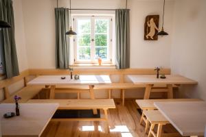 a room with wooden tables and a window at Pilgerhaus Wildsteig in Wildsteig +26 photos