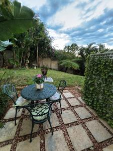 a table and chairs sitting on a patio at Cottage in Ballito in Ballito
