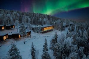 an aerial view of a building under the northern lights at Arctic Panorama Resort in Rovaniemi +32 photos