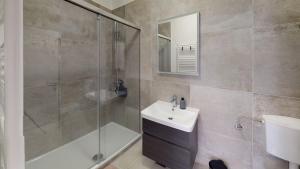 a bathroom with a shower and a sink and a mirror at Mestna Vila Krško in Krško
