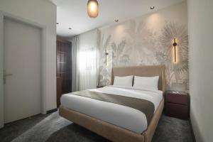 a bedroom with a large bed and a wall mural at Santino Boutique Hotel in El Alamein +45 photos