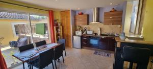 a kitchen with a table and some chairs and a table and a kitchen with at La Casa Liberta in Salavas
