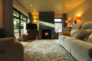 a living room with a couch and a fireplace at Havendale in Chesterfield