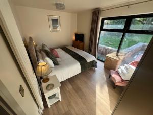 a bedroom with a bed and a large window at Havendale in Chesterfield