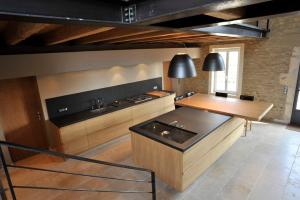a kitchen with a table and a counter top at A charming Provençal farmhouse in Mouriès