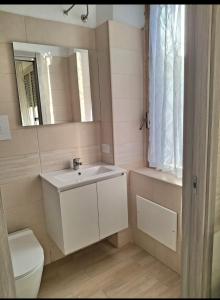 a bathroom with a sink and a toilet and a mirror at FREE HOUSE in Palmi +13 photos