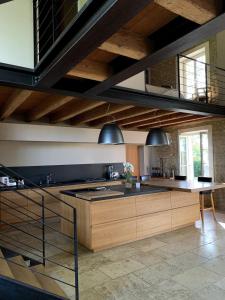 a kitchen with wooden cabinets and a large island at A charming Provençal farmhouse in Mouriès +42 photos