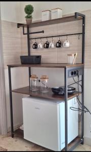 a shelf with pots and pans on it at FREE HOUSE in Palmi