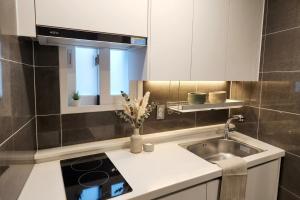 a kitchen with a sink and a counter top at Billy Hostel in Busan