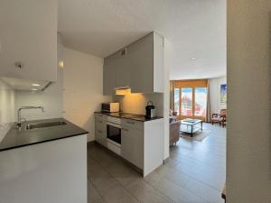 a kitchen with a sink and a stove top oven at Eiger Residence 1 in Wengen